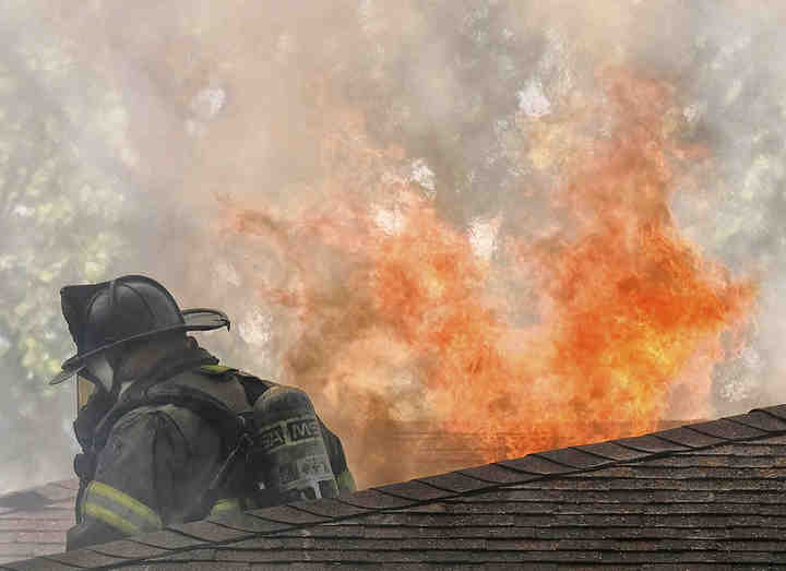 A firefighter battles a blaze at 2263 Parkwood Avenue in Toledo.   (Jeremy Wadsworth / The Blade)